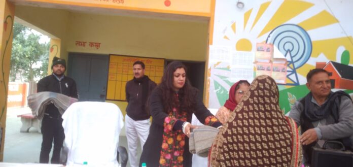 District Magistrate Medha Rupam distributing blankets in village Upeda