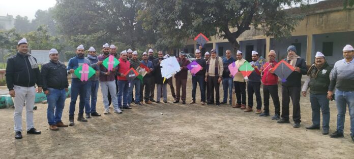 Teachers standing with kites demanding restoration of old pension