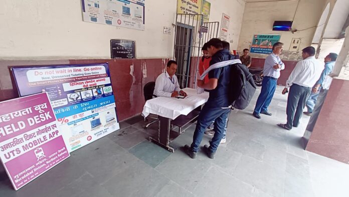 Giving information to passengers at Hapur Railway Station